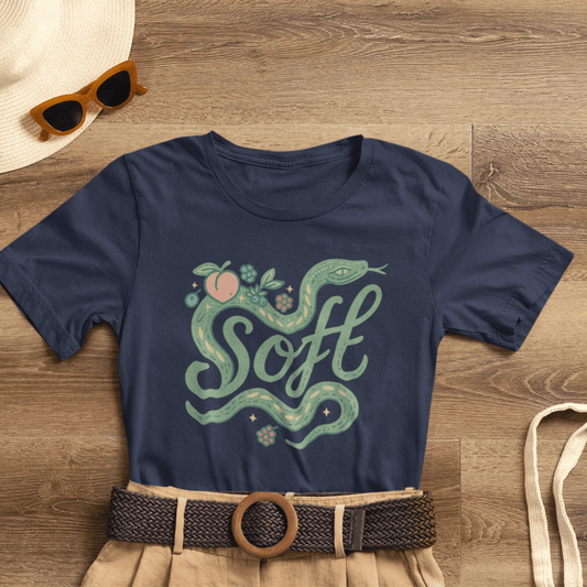 Unisex Soft Snake Graphic Tee featuring a whimsical botanical serpent design on a nature-inspired background.