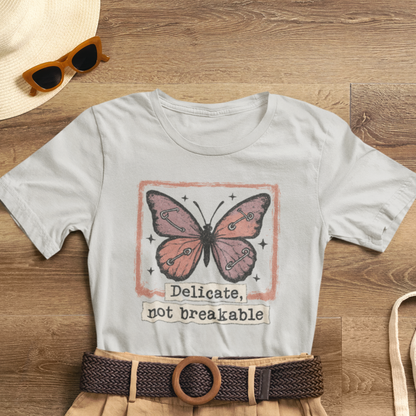 Delicate Not Breakable Butterfly Pocket Tee – Minimalist Affirmation T-Shirt, Self Love & Resilience Quote Shirt