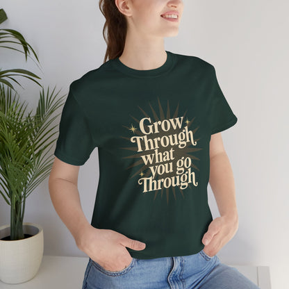 Sunburst motivational graphic T-shirt by Printify featuring the phrase "Grow Through What You Go Through" on a casual tee.