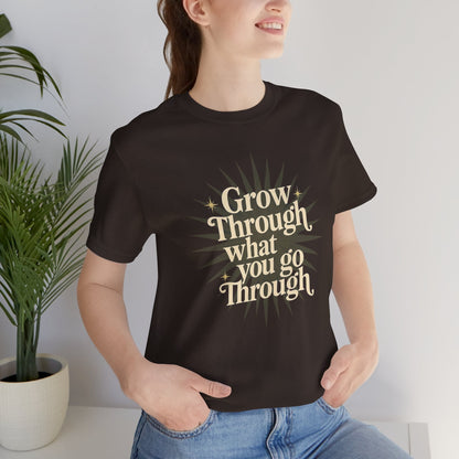 Sunburst motivational graphic T-shirt with "Grow Through What You Go Through" message, by Printify, casual and inspiring apparel.