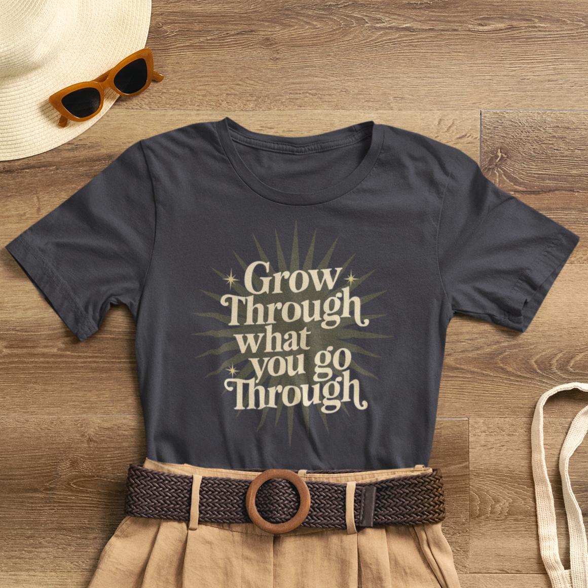 Sunburst motivational graphic T-shirt by Printify featuring the phrase "Grow Through What You Go Through" on a casual cotton tee.