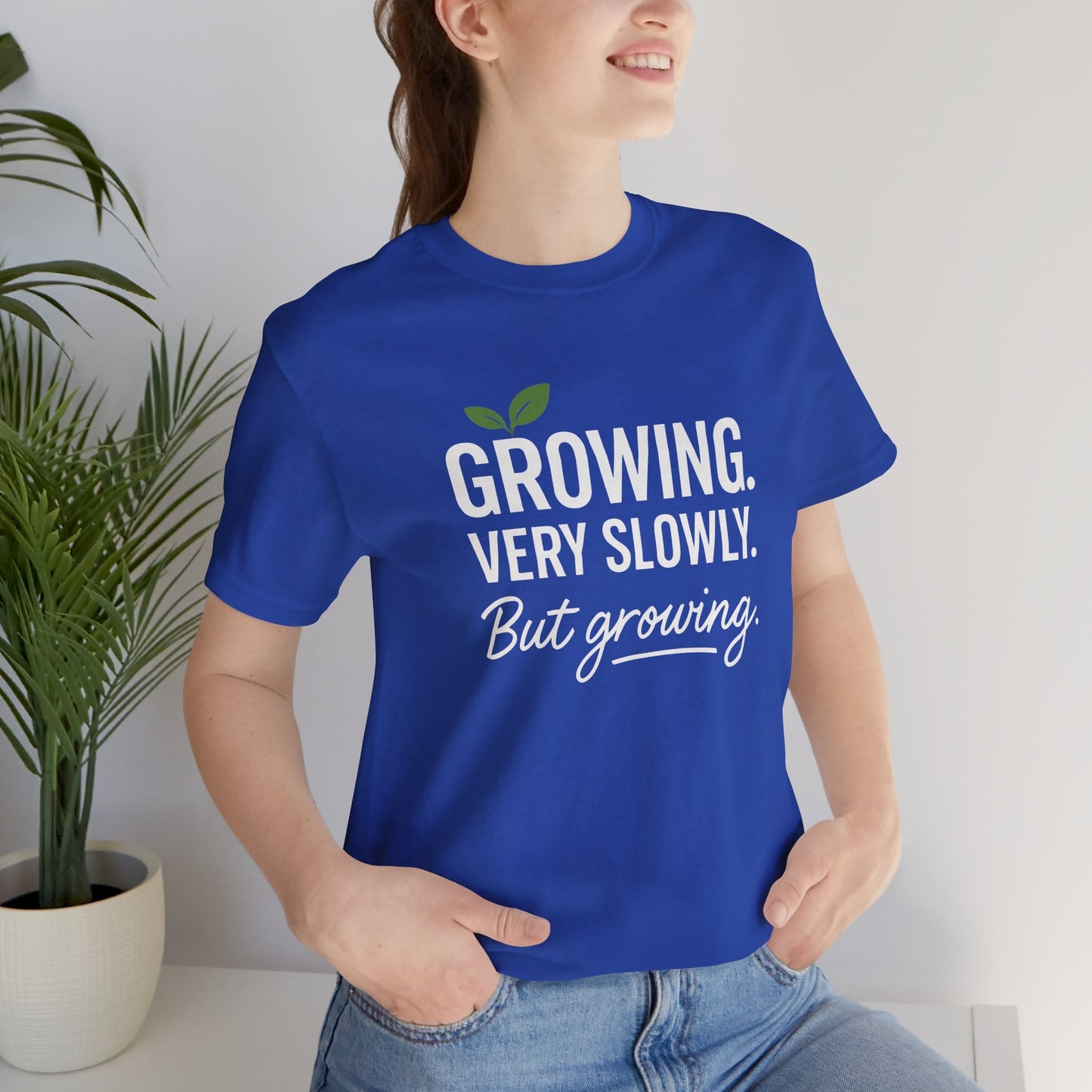 White T-Shirt with "Growing Very Slowly But Growing" text, featuring a gentle growth and emotional healing theme, by Printify.