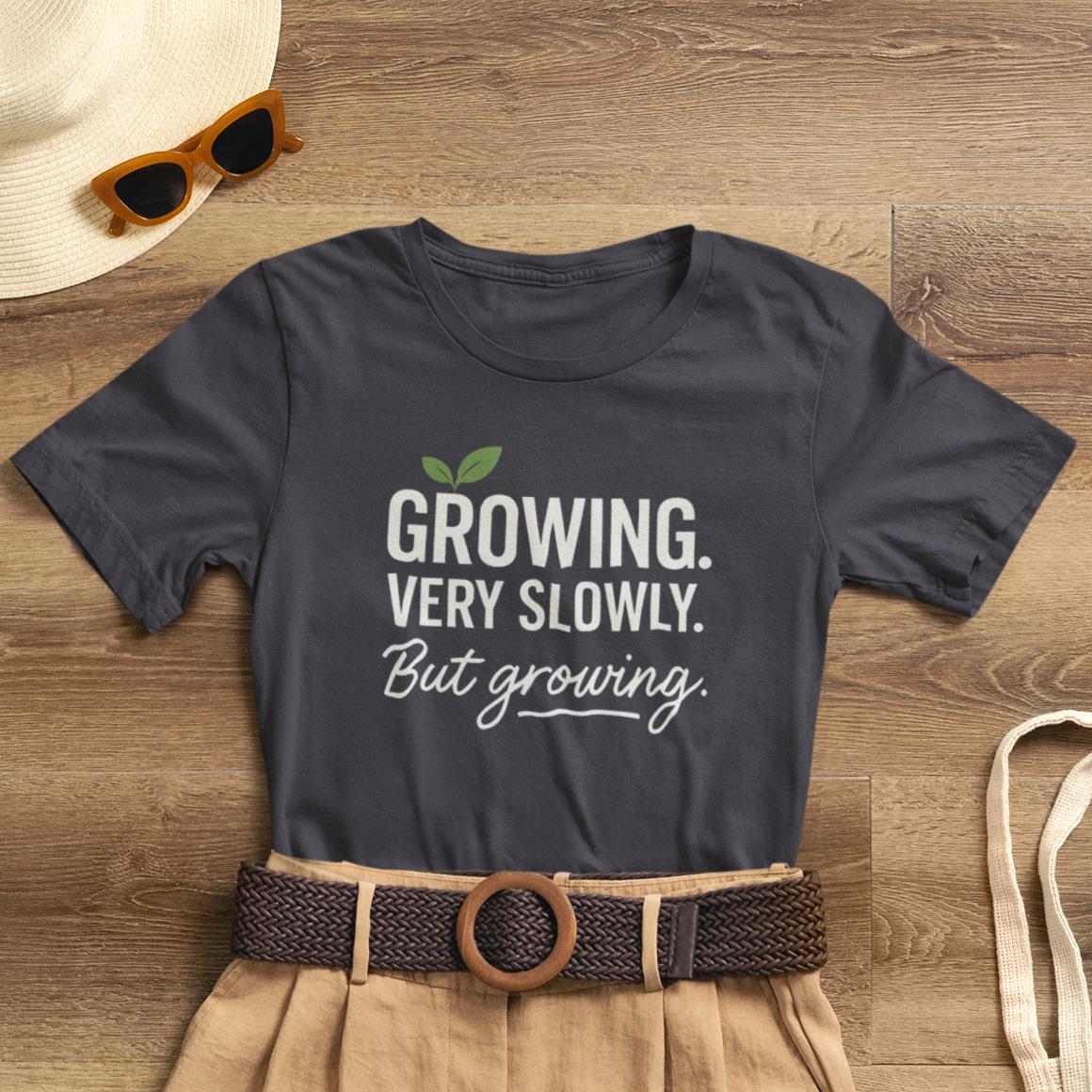 Light-colored Growing Very Slowly But Growing T-Shirt by Printify featuring gentle growth and emotional healing design.