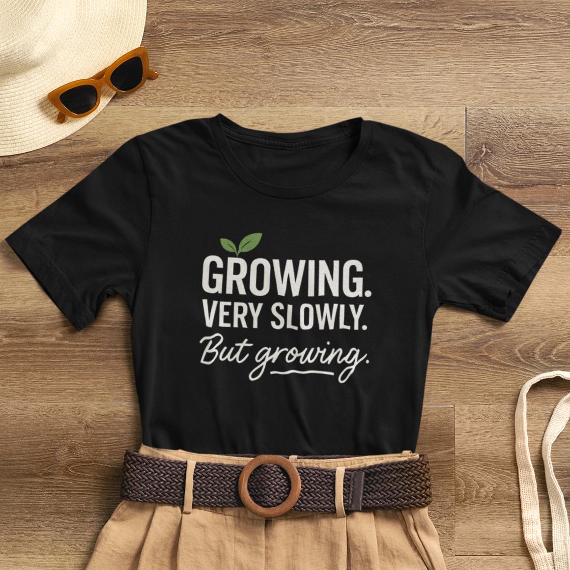 Soft cotton T-shirt featuring the "Growing Very Slowly But Growing" design, emphasizing gentle growth and emotional healing.