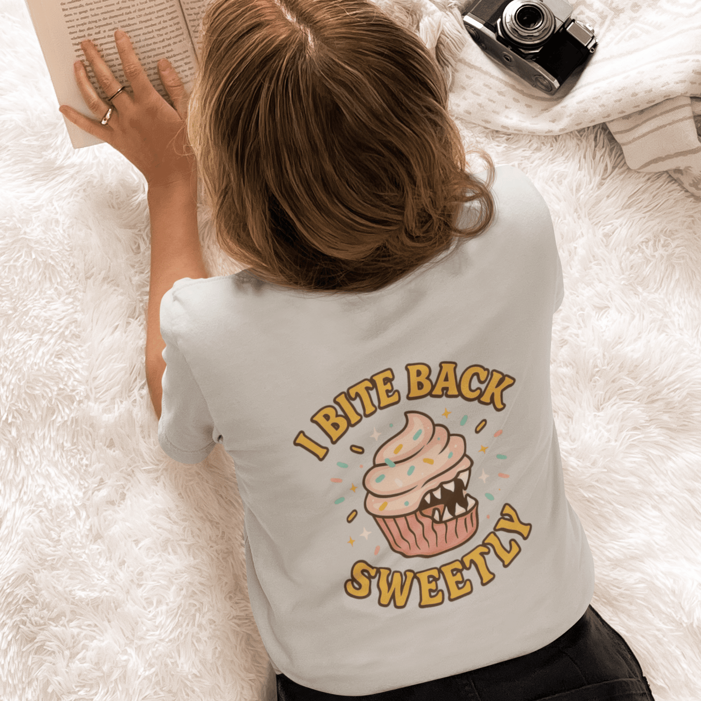 Printify I Bite Back Sweetly T-shirt with cupcake graphic and sassy quote, showing front and back design on a casual tee.