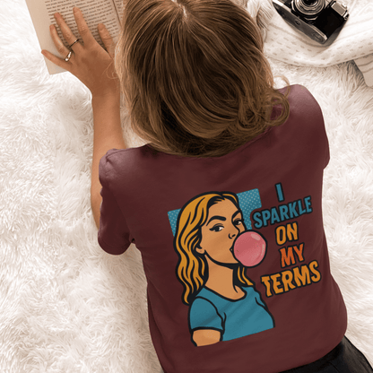 Let Me Be Clear T-Shirt with retro pop art feminist graphic and "I Sparkle on My Terms" slogan, by Printify.
