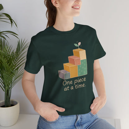 Printify One Piece at a Time T-Shirt with patchwork design, showcasing steps of gentle progress and emotional healing.