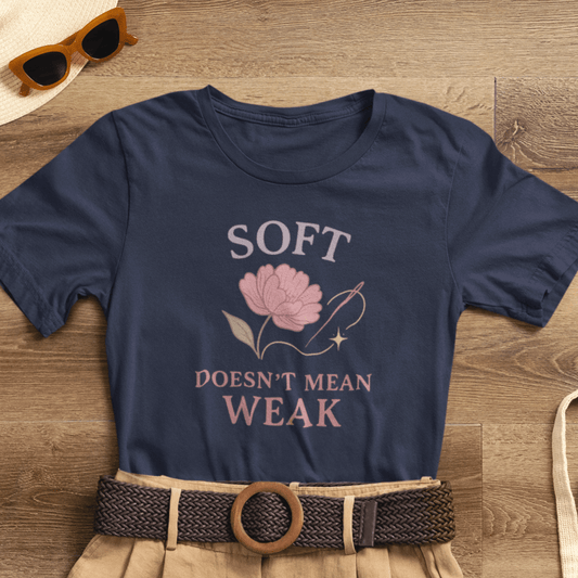 Feminist floral empowerment T-shirt by Printify featuring the slogan "Soft Doesn’t Mean Weak" on a soft cotton tee.