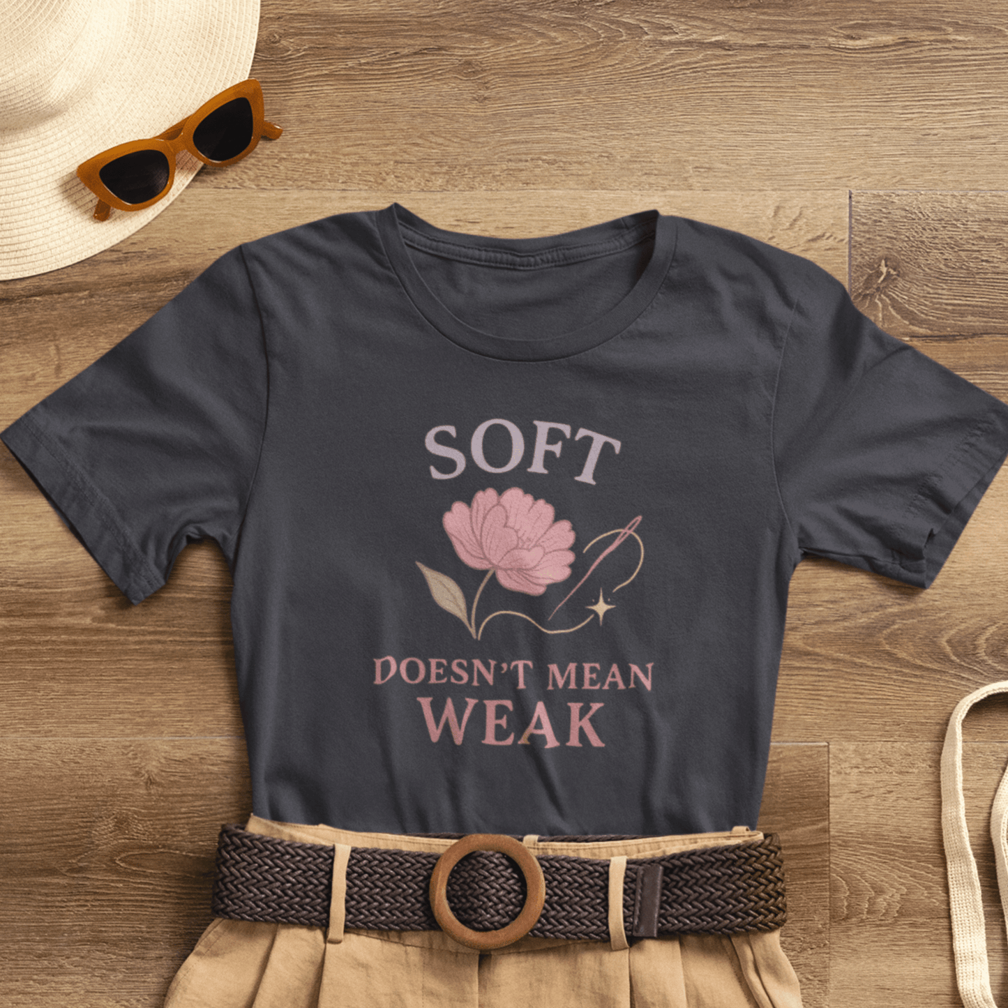 Feminist floral empowerment T-shirt from Printify featuring the "Soft Doesn’t Mean Weak" slogan on a casual tee.