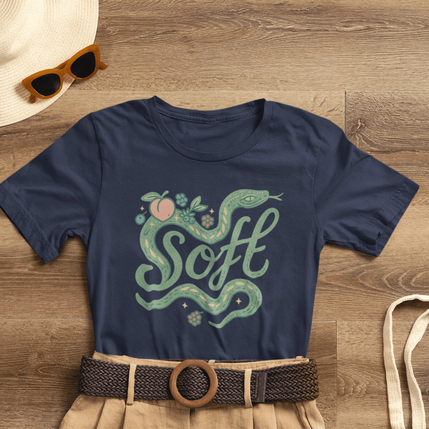 Unisex Soft Snake Graphic Tee featuring a whimsical botanical serpent design on a nature-inspired background.