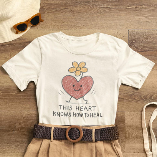 Doodle T-shirt featuring a colorful flower heart design, inspired by "This Heart Knows How to Heal" by Printify.