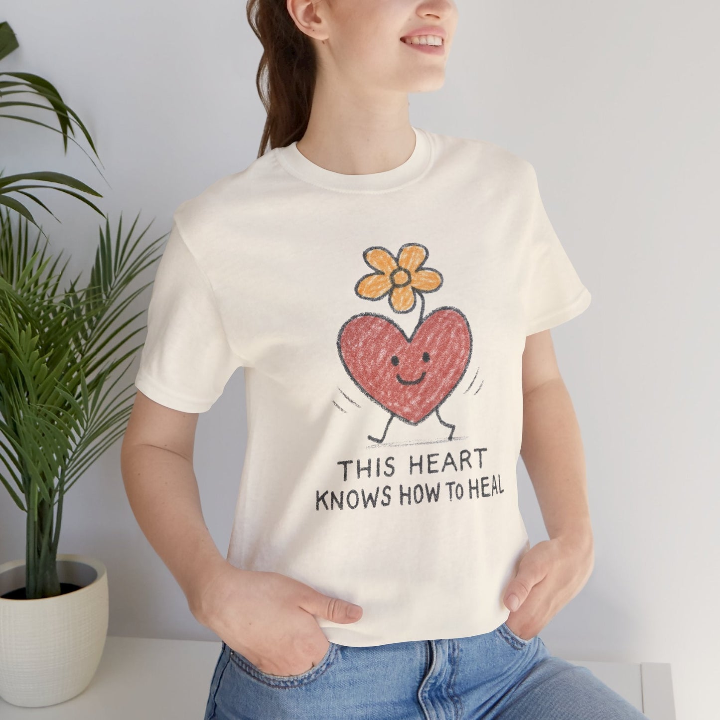 Printify Heart Knows How to Heal Doodle T-Shirt with a cute flower and heart design, showcasing a healing and positive theme.