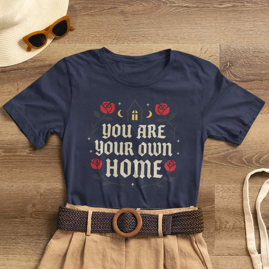 Dark floral Gothic Cottagecore T-shirt featuring "You Are Your Own Home" quote in medieval typography by Printify.